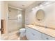 Bathroom with a shower and glass enclosure, cream colored vanity, and ample lighting at 5134 Northridge Rd # 106, Sarasota, FL 34238