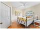 Cozy bedroom with wood floors, a ceiling fan, and a comfortable bed at 5134 Northridge Rd # 106, Sarasota, FL 34238