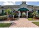 Managment Office and Clubhouse entry with manicured landscaping and shade trees at 5134 Northridge Rd # 106, Sarasota, FL 34238