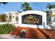 Community sign that reads 'Serenade on Palmer Ranch' surrounded by flowerbeds at 5134 Northridge Rd # 106, Sarasota, FL 34238