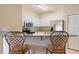Well-equipped kitchen featuring white cabinetry, granite countertops, and stainless steel appliances at 5134 Northridge Rd # 106, Sarasota, FL 34238