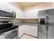 Modern kitchen featuring stainless steel appliances, white cabinets, and granite countertops at 5134 Northridge Rd # 106, Sarasota, FL 34238