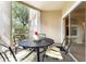 Relaxing screened patio with a round table and chairs, ideal for outdoor dining and entertaining at 5134 Northridge Rd # 106, Sarasota, FL 34238