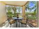 Outdoor patio with screened enclosure, table and chairs, offering a relaxing outdoor living space at 5134 Northridge Rd # 106, Sarasota, FL 34238