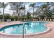 Community pool surrounded by ample seating and lush landscaping, offering a perfect relaxation spot at 5134 Northridge Rd # 106, Sarasota, FL 34238