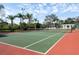 Community tennis court with a green playing surface and tall net at 5134 Northridge Rd # 106, Sarasota, FL 34238