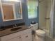 Bright blue bathroom with updated vanity, toilet, and shower/tub combo at 534 Lewis St, Englewood, FL 34223