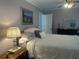 Comfortable bedroom featuring a cozy bed, artwork, ceiling fan, and natural lighting at 534 Lewis St, Englewood, FL 34223