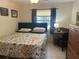 Cozy bedroom with a floral comforter, desk and dresser with natural light at 534 Lewis St, Englewood, FL 34223