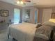 Comfortable bedroom features tile floors, a ceiling fan, and a desk with natural light at 534 Lewis St, Englewood, FL 34223