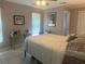 Cozy bedroom features tile floors, a ceiling fan, and a desk near a bright window at 534 Lewis St, Englewood, FL 34223