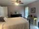 Comfortable bedroom with ceiling fan, writing desk, and black dresser at 534 Lewis St, Englewood, FL 34223