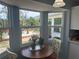 Cozy breakfast nook features a wood table near windows with a view of a landscaped patio and backyard at 534 Lewis St, Englewood, FL 34223