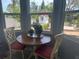 Cozy breakfast nook with a round table, cushioned chairs, and bright windows overlooking the lush yard at 534 Lewis St, Englewood, FL 34223