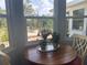 Bright breakfast nook showcases a round wooden table by a window, offering views of the backyard patio at 534 Lewis St, Englewood, FL 34223