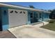 Exterior of a blue home with a garage and front porch at 534 Lewis St, Englewood, FL 34223