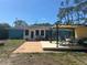 Charming home with a backyard patio, pergola, and landscaping at 534 Lewis St, Englewood, FL 34223