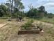 Vegetable garden, with raised beds, and a fire pit area offer outdoor relaxation and gardening at 534 Lewis St, Englewood, FL 34223