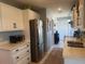 Well-lit kitchen featuring stainless steel appliances, white cabinets, and modern countertops for efficient cooking at 534 Lewis St, Englewood, FL 34223