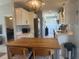 Open kitchen with a center island, stainless steel refrigerator, and ample cabinet space at 534 Lewis St, Englewood, FL 34223