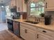 Bright kitchen featuring white cabinets, stainless steel appliances, and a view to the breakfast nook at 534 Lewis St, Englewood, FL 34223