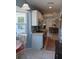 Bright kitchen boasts white cabinets and tiled floor leading into an adjacent dining space, all with lots of natural light at 534 Lewis St, Englewood, FL 34223