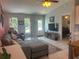 Comfortable living room with stylish sectional sofa, bright windows, and seamless flow into other areas at 534 Lewis St, Englewood, FL 34223