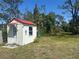 Charming outbuilding with a red roof and well-kept garden, perfect for a studio or guest house at 534 Lewis St, Englewood, FL 34223