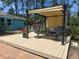 Relaxing outdoor deck featuring pergola, dining set, and built-in grill at 534 Lewis St, Englewood, FL 34223