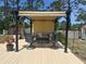 Comfortable outdoor deck featuring pergola, dining set, and built-in grill at 534 Lewis St, Englewood, FL 34223