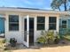 Bright sunroom with many windows, white trim, and French doors create a welcoming atmosphere at 534 Lewis St, Englewood, FL 34223