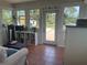 Bright sunroom with tiled flooring, lots of windows, and access to the yard at 534 Lewis St, Englewood, FL 34223