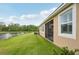 Home exterior with a tranquil pond view and spacious green backyard at 5520 Coachwood Cv, Bradenton, FL 34211