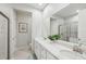 Elegant bathroom featuring double sinks, quartz countertops, and modern fixtures at 5520 Coachwood Cv, Bradenton, FL 34211