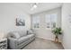Cozy bedroom with neutral colors, bright windows, and comfortable grey pull out sofa at 5520 Coachwood Cv, Bradenton, FL 34211