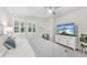 The bright bedroom has great natural light and a decorative dresser with mounted flatscreen TV at 5520 Coachwood Cv, Bradenton, FL 34211