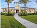 Community clubhouse with lush landscaping and sidewalks for easy accessibility at 5520 Coachwood Cv, Bradenton, FL 34211