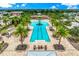 Aerial view of community pool with seating and palm trees, perfect for relaxation and recreation at 5520 Coachwood Cv, Bradenton, FL 34211
