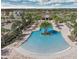 View of community pool with seating, palm trees and playground at 5520 Coachwood Cv, Bradenton, FL 34211