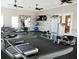 A spacious gym featuring weight machines, treadmills and ceiling fans at 5520 Coachwood Cv, Bradenton, FL 34211