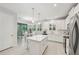 Modern kitchen featuring stainless steel appliances, a center island, and stylish white cabinetry at 5520 Coachwood Cv, Bradenton, FL 34211