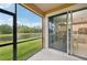 Spacious screened lanai featuring pond view with seamless indoor-outdoor living at 5520 Coachwood Cv, Bradenton, FL 34211