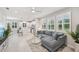Bright, open-concept living space with natural light, modern furnishings, and tiled flooring at 5520 Coachwood Cv, Bradenton, FL 34211