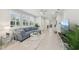 Comfortable living area with neutral decor, plantation shutters, and tile flooring at 5520 Coachwood Cv, Bradenton, FL 34211