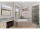 Elegant bathroom with a soaking tub, shower, and vanity at 5637 Arnie Loop, Bradenton, FL 34211