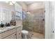 Bathroom featuring a step-in shower with glass doors, granite vanity and window for natural light at 5637 Arnie Loop, Bradenton, FL 34211