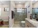 Ensuite bathroom featuring a step-in shower with glass doors and granite vanity at 5637 Arnie Loop, Bradenton, FL 34211