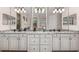 Bright bathroom showcasing double sinks, white cabinetry, granite counters and modern fixtures at 5637 Arnie Loop, Bradenton, FL 34211