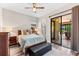 Bedroom showcasing ceiling fan, wood floors, sliding glass doors to screened lanai, and ensuite bathroom at 5637 Arnie Loop, Bradenton, FL 34211