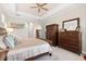 Charming bedroom with classic furniture, tray ceiling, and ensuite access at 5637 Arnie Loop, Bradenton, FL 34211